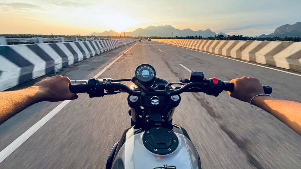 Motorcycle rider perspective on scenic highway